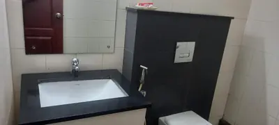 a bathroom with a sink and a toilet and a mirror at hazmi inn in Perintalmanna