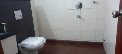 a bathroom with a white toilet and a shower at hazmi inn in Perintalmanna