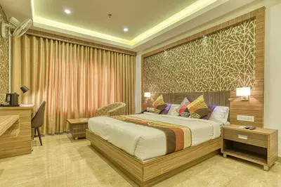 a hotel room with a bed and a desk at VKJ INTERNATIONAL in Perumbavoor