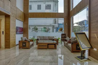 a living room with a flat screen tv in a building at VKJ INTERNATIONAL in Perumbavoor