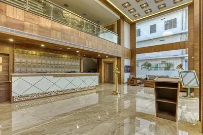 a large lobby with a desk and a building at VKJ INTERNATIONAL in Perumbavoor