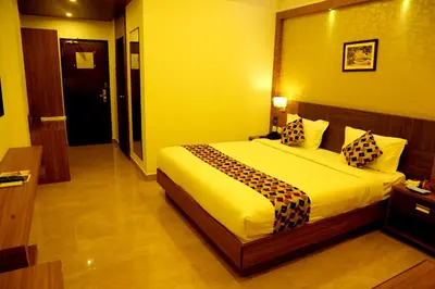 a bedroom with a large bed in a room at VKJ INTERNATIONAL in Perumbavoor