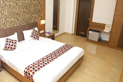 a bedroom with a bed with two pillows on it at VKJ INTERNATIONAL in Perumbavoor