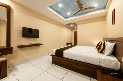 a bedroom with a bed and a skylight at MARZA INN in Kalpetta