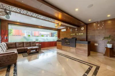 a lobby with a couch and a table at MARZA INN in Kalpetta