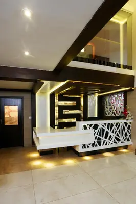 a lobby with a white bench in a building at moriz inz in Mysore
