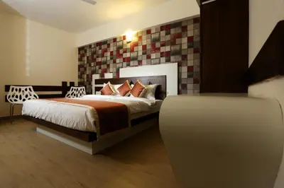 a bedroom with a king sized bed in a room at moriz inz in Mysore