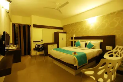 a bedroom with a large bed and a table and chairs at moriz inz in Mysore