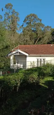 a white house with a red roof at Dew Drops Cottage Coonoor By Lexstays in Coonoor