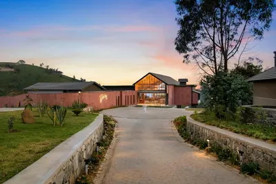 a house on a hill with a driveway at WelcomHeritage Ayatana Ooty in Ooty