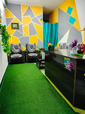 a office with a green carpet in a room at Teja Residency in Alāndurai