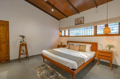 a bedroom with a large bed in a room at StayVista at Mountain Rain - Breakfast Included in Wayanad