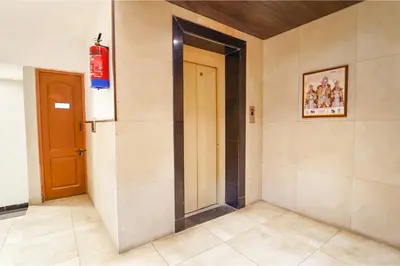 a hallway with a door in a room at FabHotel Karpagam - 900m from Nehru Stadium in Coimbatore