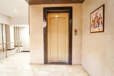 a hallway with a door in a building at FabHotel Karpagam - 900m from Nehru Stadium in Coimbatore