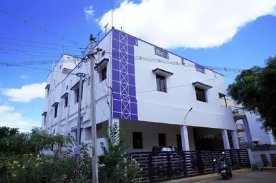 a white building with a blue detailing on it at WHITE HOUSE - 3BHK Elegant Apartment in Coimbatore