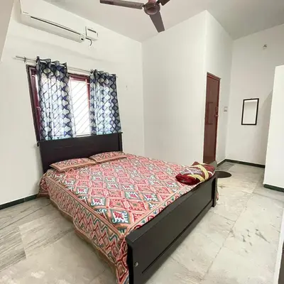 a bedroom with a large bed in a room at WHITE HOUSE - 3BHK Elegant Apartment in Coimbatore