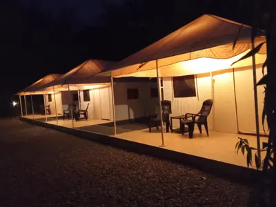 a row of tents lit up at night at Torch Ginger Homestay in Sultan Bathery