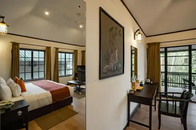 a bedroom with a bed and a desk and a desk at The Hive, Wayanad in Wayanad