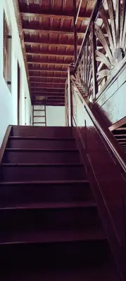 a set of stairs in a building with a wooden ceiling at Aramana Ayurvedic Wellness Centre & Homestay in Palakkad
