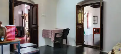 a dining room with a table and a mirror at Aramana Ayurvedic Wellness Centre & Homestay in Palakkad