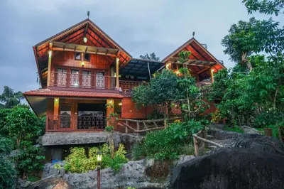 a house on top of a mountain at Niyatma Wayanad Pool Resort by VOYE HOMES - Inside Coffee Plantation in Wayanad