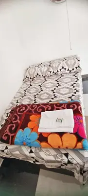 a bed with towels on top of it at Johns Villa in Sultan Bathery