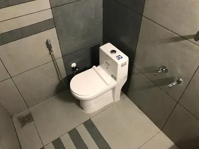 a bathroom with a toilet in a stall at PARTHO home stay in Padinjarathara