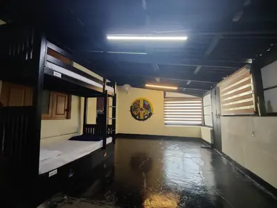 a dark room with two bunk beds in it at Multiple Stories, Wayanad in Wayanad