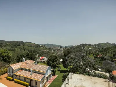 an aerial view of a house with a yard at Belair Resorts in Kotagiri