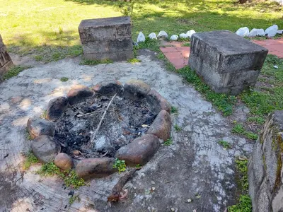 a fire pit in the middle of a yard at THE TIGER PAW RESORT in Masinagudi