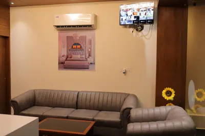 a living room with a couch and a flat screen tv at HYDEPARK REGENCY in Palakkad