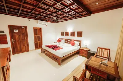 a bedroom with a bed and a wooden ceiling at Cherai Beach View Heritage in Cherai Beach