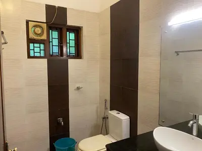 a bathroom with a toilet and a sink and a window at 