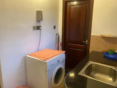 a washing machine in a bathroom with a sink at 