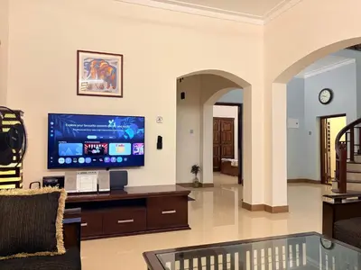 a living room with a flat screen tv on the wall at 