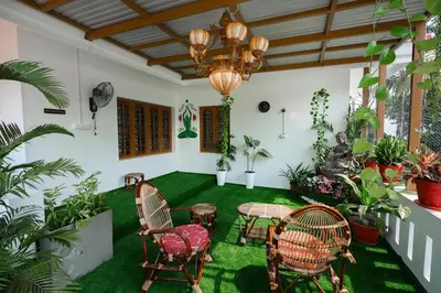 a room with a table and chairs and plants at Parudeesa - Heavenly- Luxurious Palace look-Near CBD - Kerala - India with Breakfast in Kāladi