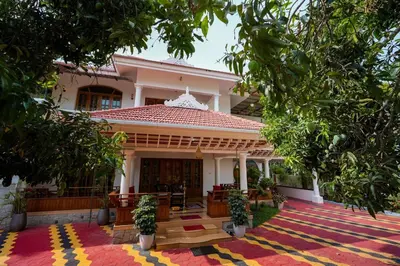 a house with a large rug in front of it at Parudeesa - Heavenly- Luxurious Palace look-Near CBD - Kerala - India with Breakfast in Kāladi