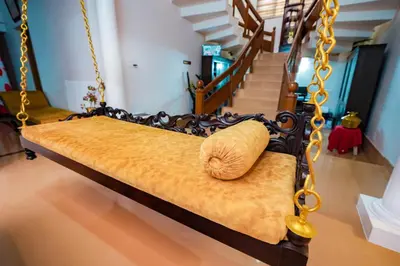 a swinging bed with a pillow on it in a room at Parudeesa - Heavenly- Luxurious Palace look-Near CBD - Kerala - India with Breakfast in Kāladi