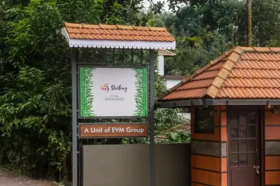 a sign for a unit of fm group in front of a building at Sterling Vythiri Wayanad in Wayanad
