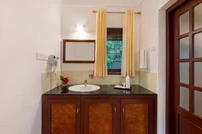 a bathroom with a sink and a window at Sterling Vythiri Wayanad in Wayanad