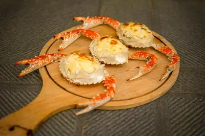 a wooden cutting board with four crabs on it at Sterling Vythiri Wayanad in Wayanad