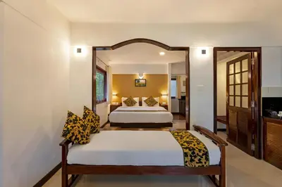 a bedroom with a bed and a large mirror at Sterling Vythiri Wayanad in Wayanad