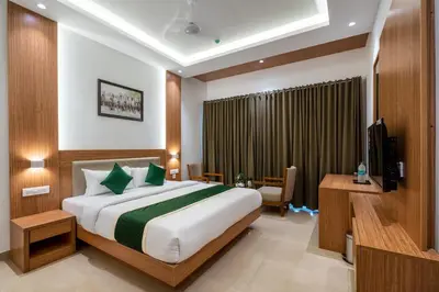 a hotel room with a bed and a television at Hotel Panoramic in Ernakulam