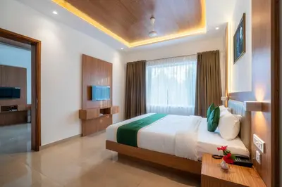 a bedroom with a large bed and a window at Hotel Panoramic in Ernakulam