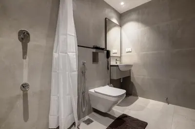a bathroom with a shower and a toilet and a sink at Hotel Panoramic in Ernakulam