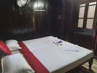 a white bed with pills and papers on top of it at Homely Homestay in Kalpetta