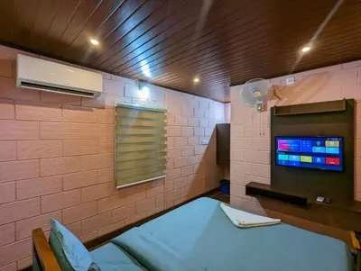 a hospital room with a bed and a tv at The Wayanad Club in Sultan Bathery