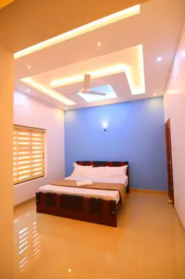 a bedroom with a bed with a blue wall at SILVERY MOON Resort in Tariyod