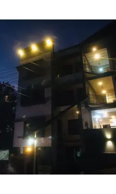 a building with lights on top of it at night at Redbell Inn Airport Hotel in Kondotti