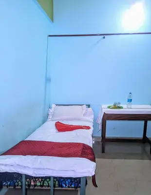 a hospital bed in a room with a blue light at VKR MENS ROOM (Gents Only) in Kozhikode